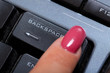 woman finger pushes "Backspace" button