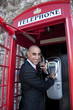 Business Man on the public phone Business Man on the public phone