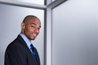 Smiling businessman beside a window