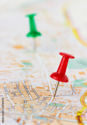 Photo: Red and green pushpin on a map Red and green pushpin on a map