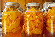 Glass jars of home canned peaches