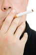 A man with a cigarette in his mouth.