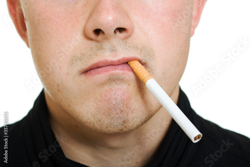 Photo: A man with a cigarette in his mouth. A man with a cigarette in his mouth.