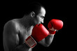 Young Boxer fighter over black background