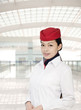 Asian flight attendant in airport terminal