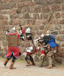Fight between the pedestrian knights in a heavy armor