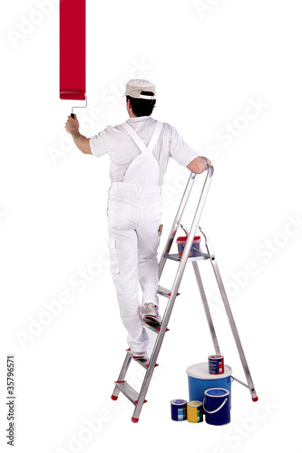 Photo : Painter standing on a ladder Painter standing on a ladder