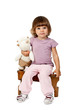 little girl sitting on a wooden stool