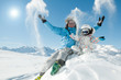 Winter fun - happy skiers playing in snow Winter fun - happy skiers playing in snow
