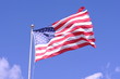 Tattered U.S. Flag Against Blue Sky in Wisconsin