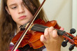 Young girl with violin focused on hand