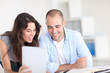 Foto: Workmates working on project with electronic tablet Workmates working on project with electronic tablet