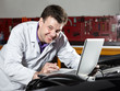 Motor mechanic is tuning the engine of a car