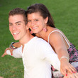 Photo: happy piggyback couple with perfect smiles happy piggyback couple with perfect smiles
