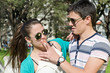 men and women with cigarette in the park men and women with cigarette in the park