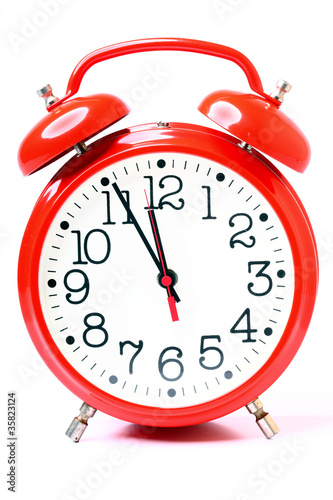 Photo: red old style alarm clock isolated red old style alarm clock isolated