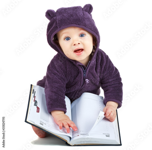 Photo: Child with a book on white background Child with a book on white background