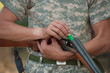 The hunter charges a shot-gun, a close up The hunter charges a shot-gun, a close up