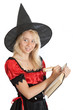 teenager girl in Halloween witch reads magic book