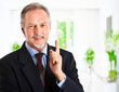 Happy businessman pointing up