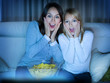 Mother with Daughter watching film on TV