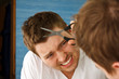 Photo: Young man preparing in mirror to cut hair himself Young man preparing in mirror to cut hair himself