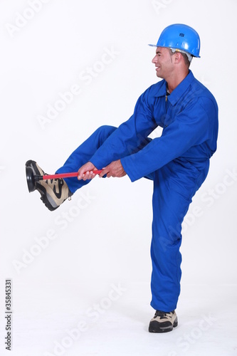 Photo: Tradesman unblocking a stoppage using a plunger Tradesman unblocking a stoppage using a plunger
