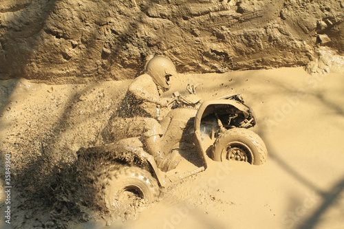 Photo: man badly stuck in mud with his quadbike man badly stuck in mud with his quadbike