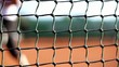 Tennis Net with Tennis Player in the Background