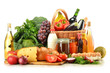 Groceries in wicker basket including vegetables and fruits Groceries in wicker basket including vegetables and fruits