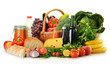 Groceries in wicker basket including vegetables and fruits Groceries in wicker basket including vegetables and fruits