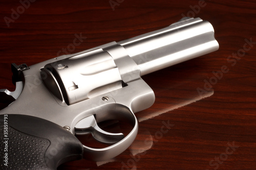 Photo: Close-up shot of .357 revolver on wooden surface Close-up shot of .357 revolver on wooden surface