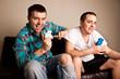 Photo: Two attractive guys having fun while playing video games Two attractive guys having fun while playing video games