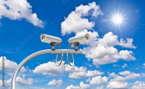 Photo: outdoor cctv cameras against blue sky and sunshine outdoor cctv cameras against blue sky and sunshine