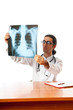 Male doctor looking at x-ray image