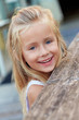 Portrait of a smiling blond hairy, beautiful little girl