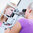 optometry concept - pretty, young female patient having her eyes