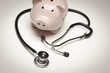 Piggy Bank and Stethoscope with Selective Focus Piggy Bank and Stethoscope with Selective Focus