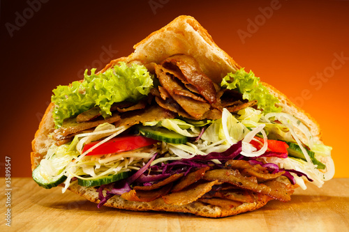 Photo: Kebab - grilled meat, bread and vegetables Kebab - grilled meat, bread and vegetables