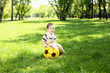 Little boy in the park playing with a ball