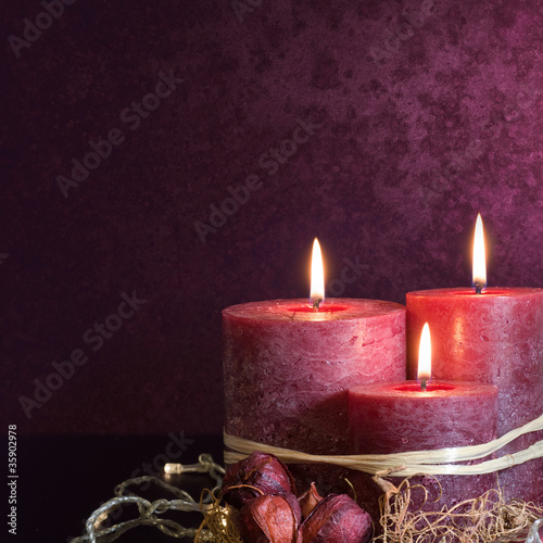 Photo: Three candles in purple Three candles in purple