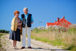 Happy senior couple and house