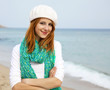 Young beautiful girl sitting at the beach