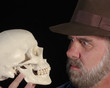 A Man in a Fedora Examines a Skull A Man in a Fedora Examines a Skull
