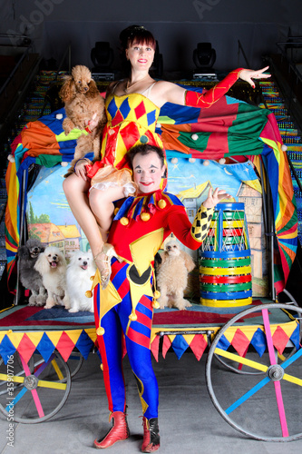 Photo: Clown lift up woman poodle circus arena Clown lift up woman poodle circus arena