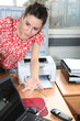 Young woman leaning on a desk
