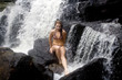 Blond sits on rock