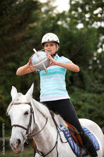 Photo: young woman playing horse-ball young woman playing horse-ball