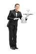 Photo: Waiter holding a tray with a glass of cocktail on it Waiter holding a tray with a glass of cocktail on it