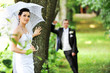groom and  bride with umbrella